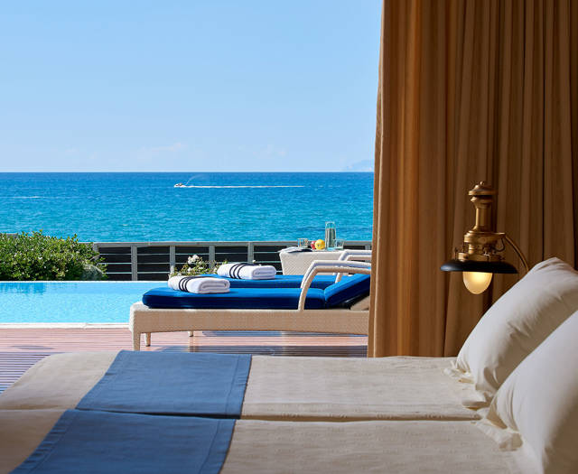 Aldemar Olympian Village Olympia Suite beds and view of the yard